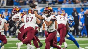 Washington Commanders quarterback Jayden Daniels looks to pass against the Detroit Lions