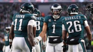 Philadelphia Eagles stars Jalen Hurts, A.J. Brown and Saquon Barkley celebrating after a touchdown against Green Bay