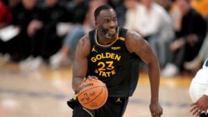 Golden State Warriors' Draymond Green dribbles the ball against the Minnesota Timberwolves during the 2025 NBA Playoffs.