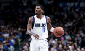 Dallas Mavericks guard Kyrie Irving controls the ball against the Charlotte Hornets during the second half at American Airlines Center.