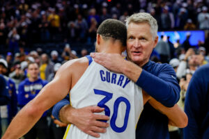 Golden State Warriors guard Stephen Curry embraces head coach Steve Kerr