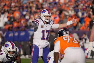 Buffalo Bills quarterback Josh Allen signals to the offensive line a play during first half action at Empower FIeld at Mile High