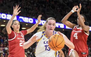 Oklahoma Sooners forward Brooklyn Stewart (21) and Oklahoma Sooners forward Caya Smith (4) defend Louisiana State Tigers forward