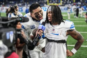 Detroit Lions offensive tackle Penei Sewell (58) interrupts as running back Jahmyr Gibbs (0) is being interviewed after 44-30