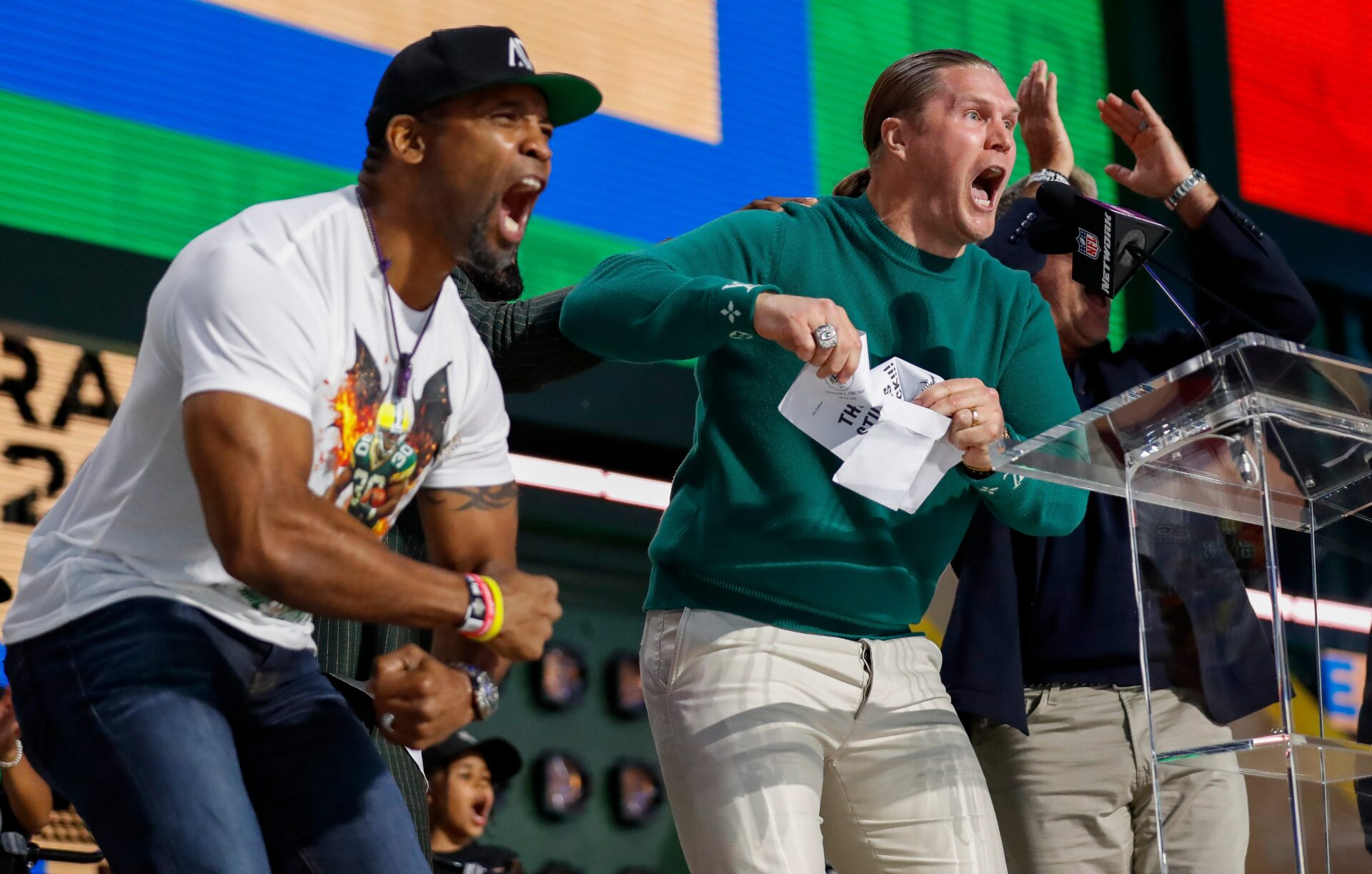 Former Green Bay Packers running back Ahman Green and former linebacker Clay Matthews hype up the crowd after reading a note