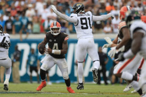 Cleveland Browns quarterback Deshaun Watson (4) runs past Jacksonville Jaguars defensive end Arik Armstead (91) during the