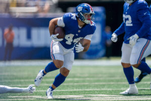 New York Giants running back Cam Skattebo (44) runs with the ball during a preseason opening game between the New York Giants