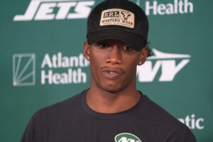 New York Jets wide receiver Garrett Wilson (5) answers questions during a press conference following a practice for the New York