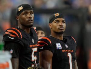 Cincinnati Bengals wide receiver Tee Higgins (5) and wide receiver Ja'Marr Chase (1) watch the score board as their team lose to