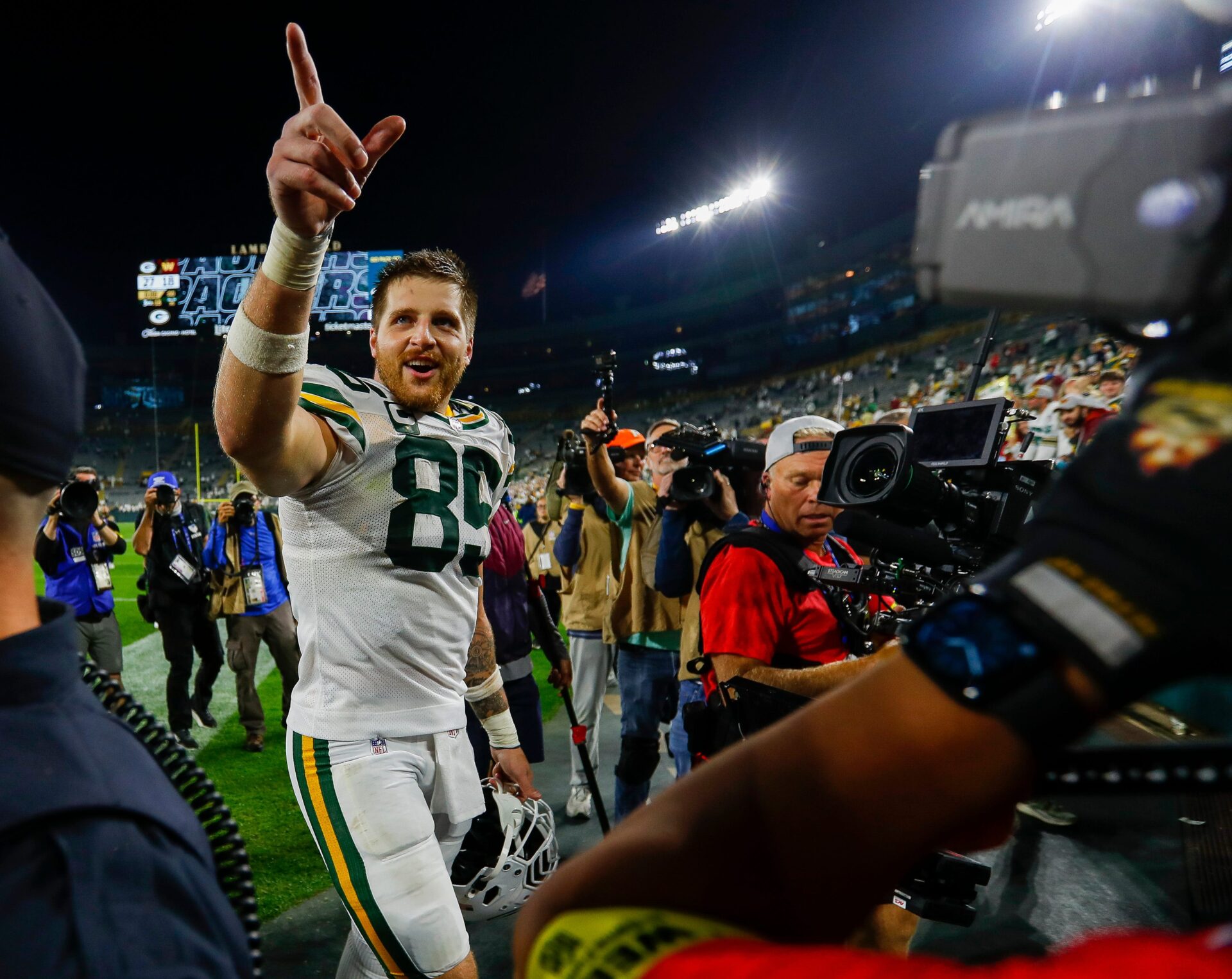 Green Bay Packers tight end Tucker Kraft (85) points to the crowd as he walks off the field after defeating the Washington
