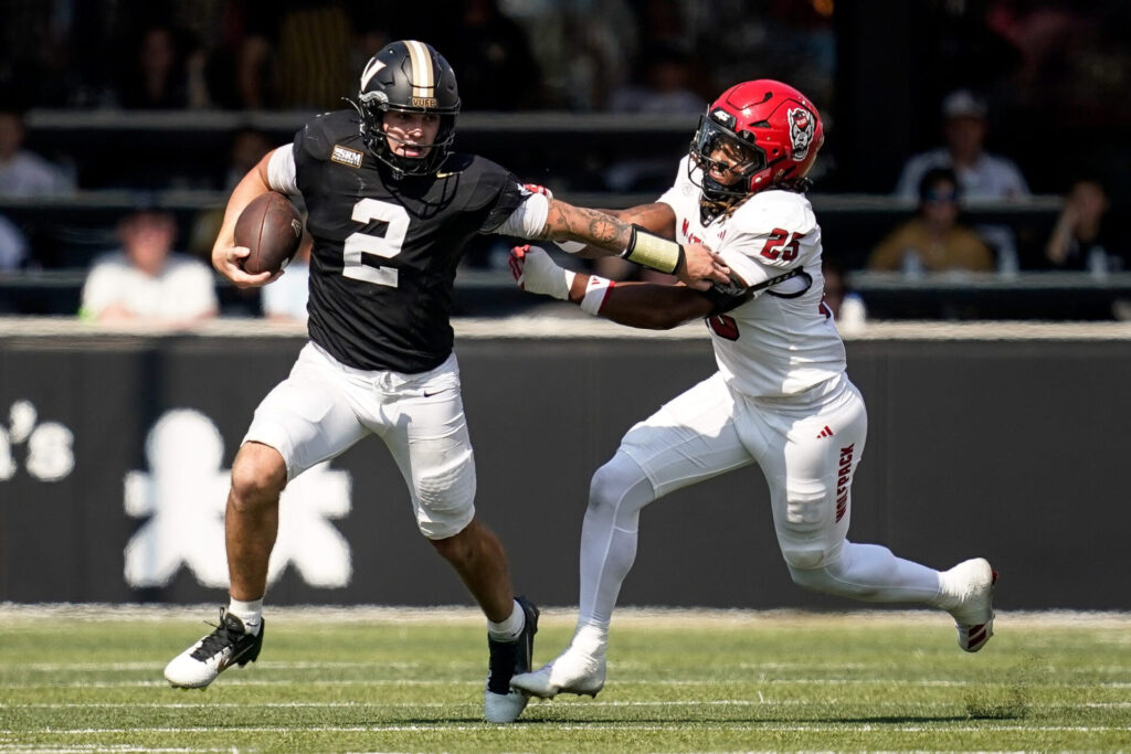 Vanderbilt quarterback Jared Curtis (2) evades NC State linebacker Sterling Dixon (25) during the fourth quarter at FirstBank