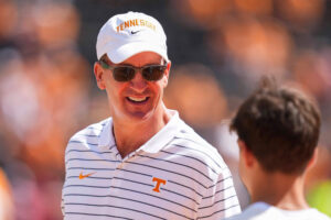 Peyton Manning smiles at a fan on the sidelines before Tennessee vs. Georgia at Neyland Stadium in Knoxville, Tennessee, on