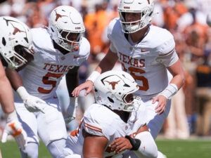 Texas quarterback Arch Manning (16) calls out instructions to his line before the snap during a college football game against