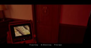 The player holds a CRTV to a door with dials and months on it in Silent Hill Townfall.