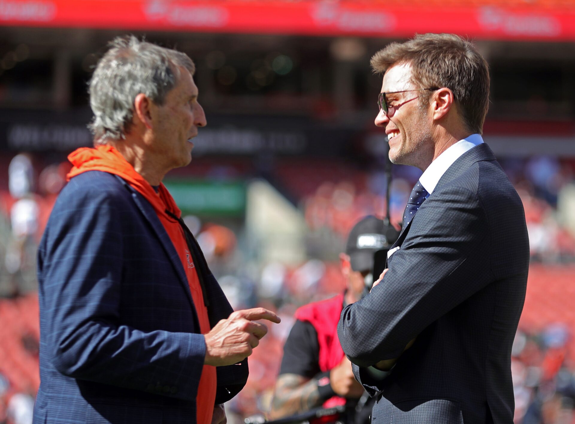 Former Browns quarterback Bernie Kosar, left, chats with former NFL quarterback Tom Brady before a game Sept. 8, 2024, in
