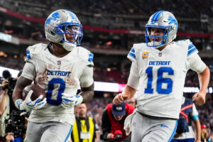 Detroit Lions running back Jahmyr Gibbs (0) celebrates a touchdown against Arizona Cardinals with quarterback Jared Goff (16)